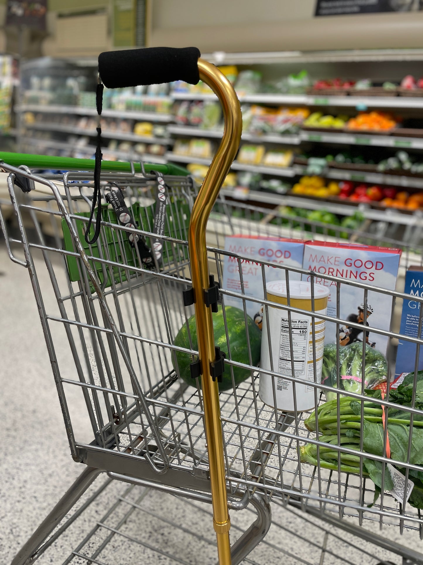 gold cane clipped to cart