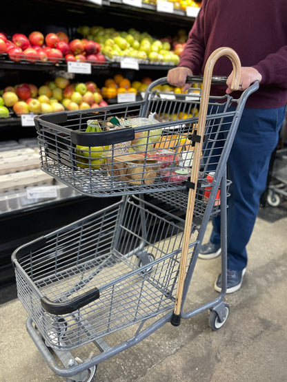 wooden cane attached to side of shopping cart