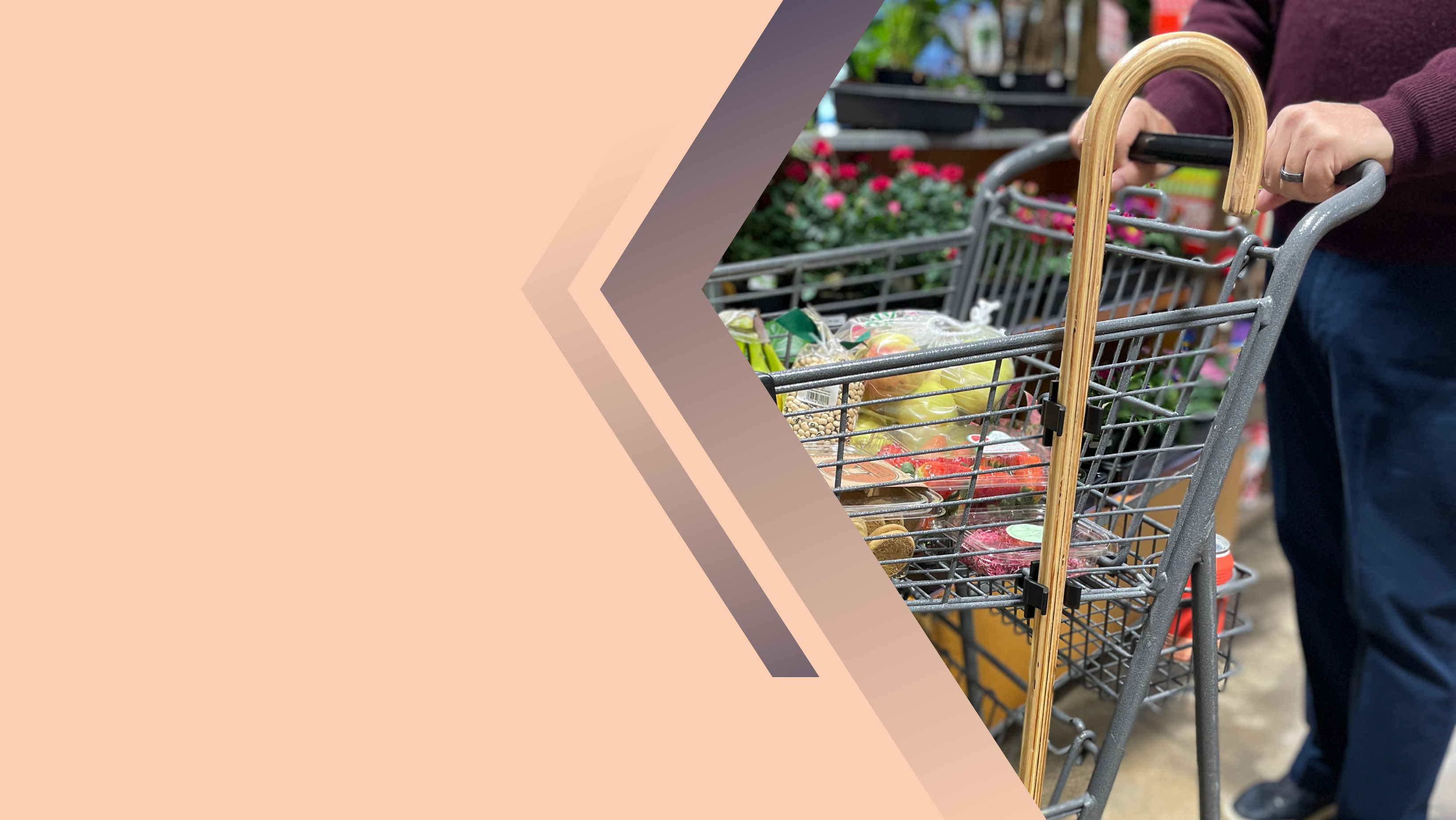 a cane attached to the side of a grocery shopping cart with Klip2Kart cane clips